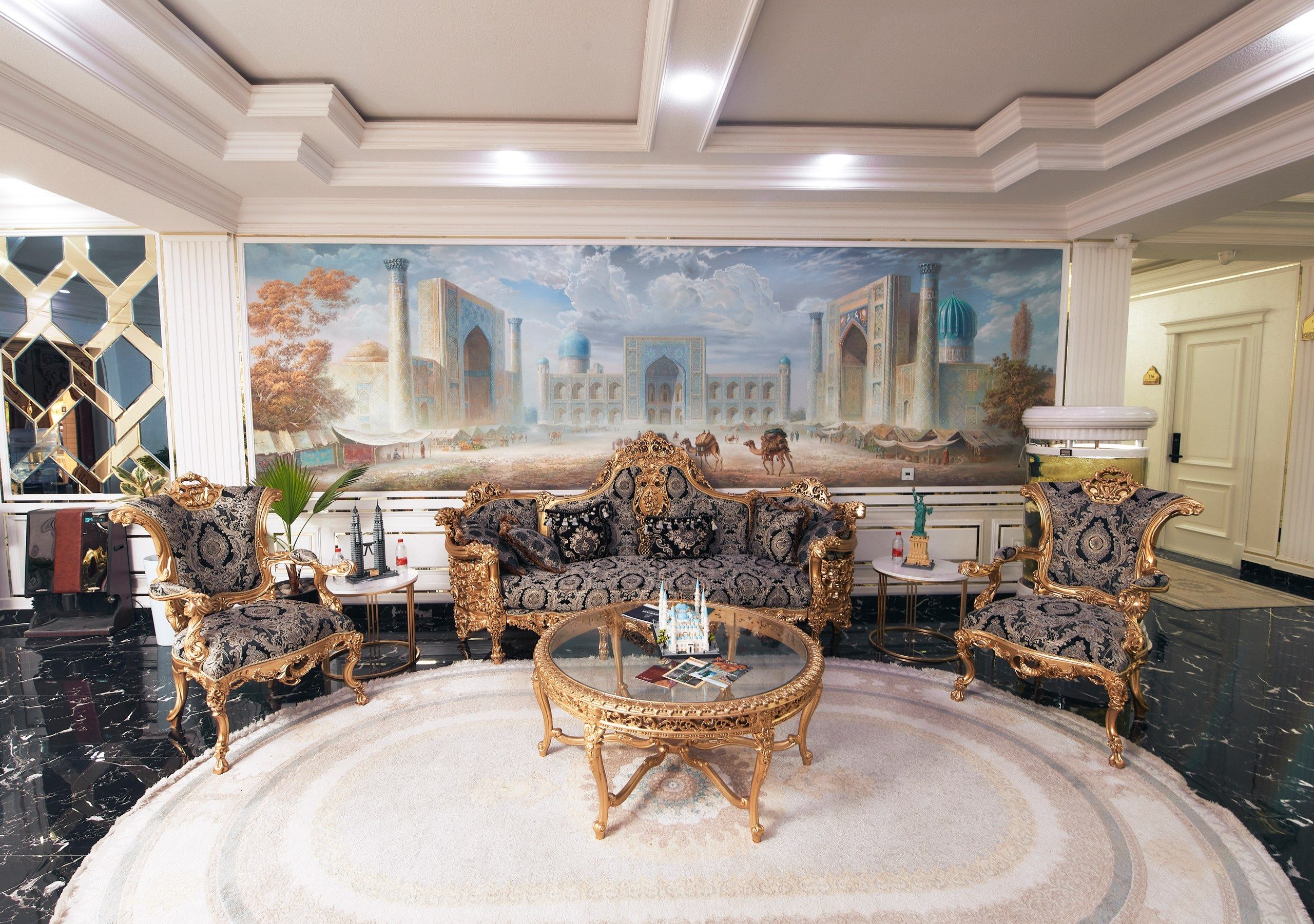 A luxurious living room with ornate furniture, a large mural, and a marble floor.