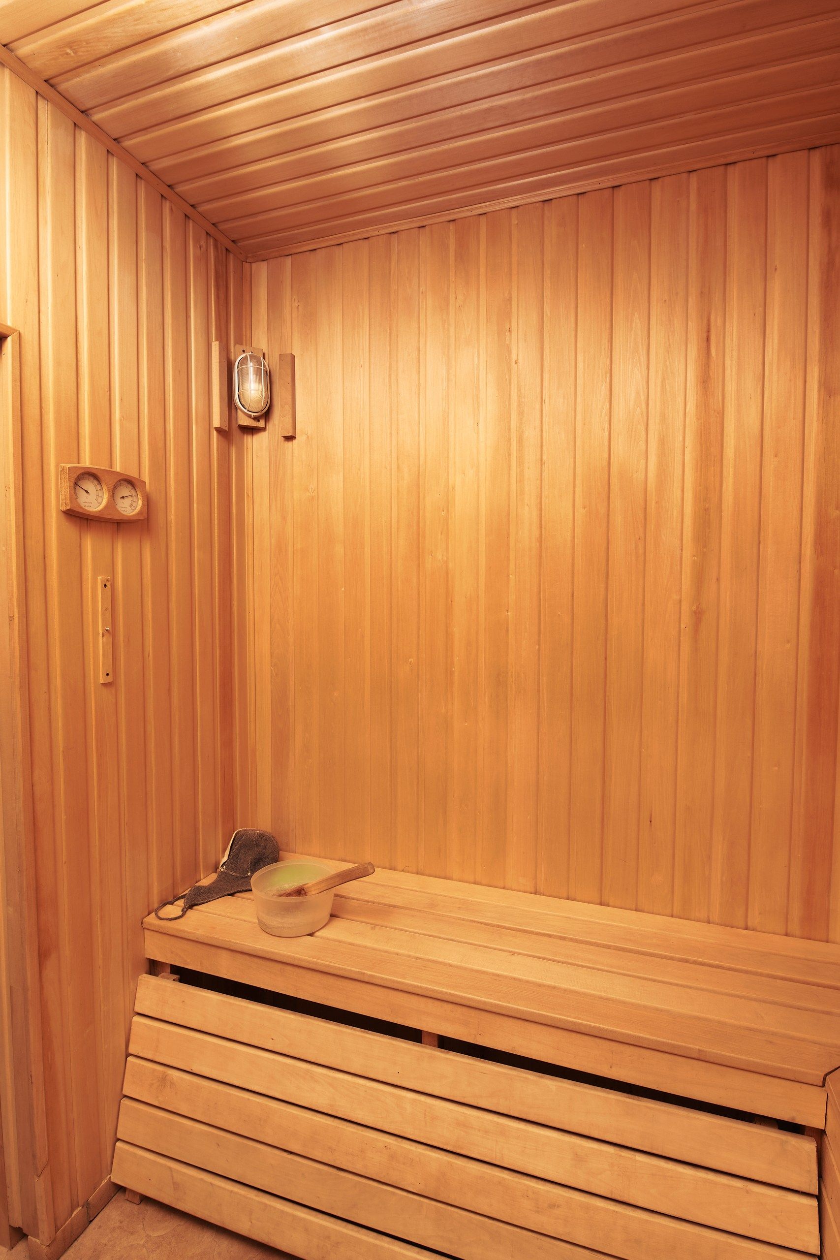 A sauna room with wooden walls and benches.