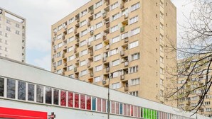 Um edifício residencial de vários andares, com varandas e uma fileira de janelas.