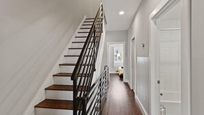 A staircase with wooden steps and black railings leading to a landing. - Skyline Best Roofdeck Views 2 Miles Penn Chop (Philadelphia)