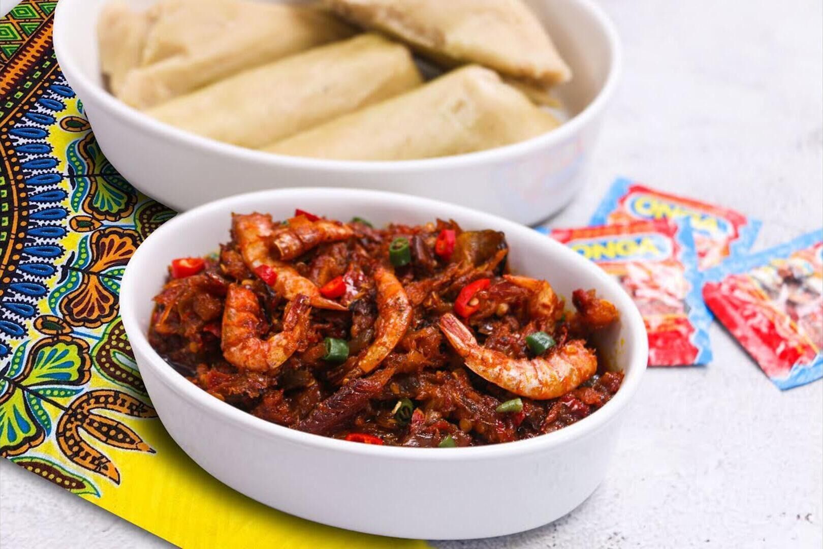 A bowl of shrimp dish with a colorful background.