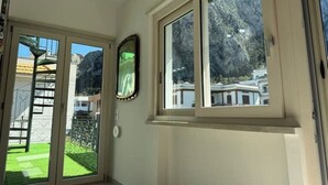 A room with a large window overlooking a mountainous landscape. - 2 Bedroom Apartment in PALERMO (PALERMO)