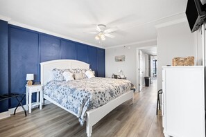 A bedroom with a bed, nightstands, a ceiling fan, and a white wardrobe. - Renovated Oceanfront Condo that sleeps 6 with dishwasher in Myrtle Beach (Myrtle Beach)