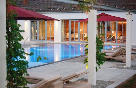 Una piscina al aire libre de temporada, sombrillas