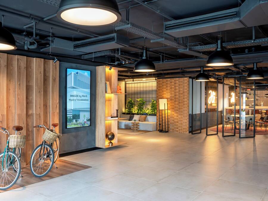 A modern interior with bicycles, a wooden wall, and a seating area.