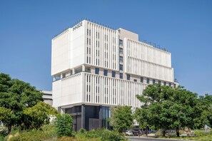 A modern building with a white facade and multiple windows.