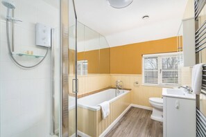 A modern bathroom with a glass shower enclosure, a freestanding bathtub, and a white sink. - Pass the Keys | Charming 4 Bed Cottage in Herts Countryside (Sacombe)