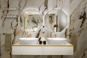 A bathroom with two large white sinks, a mirror, and marble walls. - SWAN Dolce Vita, a luxurious Venetian getaway with exclusive amenities (Venezia)
