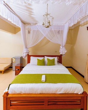 A neatly made bed with a white and green bedspread, a wooden headboard, and a canopy with white drapes. - Family-sized unique private villa w/an office & kitchen, super close to the city (Kampala)