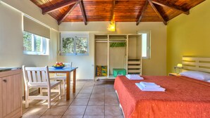 A bedroom with a bed, a desk, a chair, a wardrobe, and a window. - Cozy Studio with Swimming Pool Near the Sea (Chania)