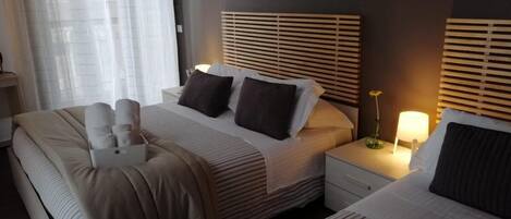 Classic Quadruple Room, City View | Down comforters, desk, laptop workspace, blackout drapes