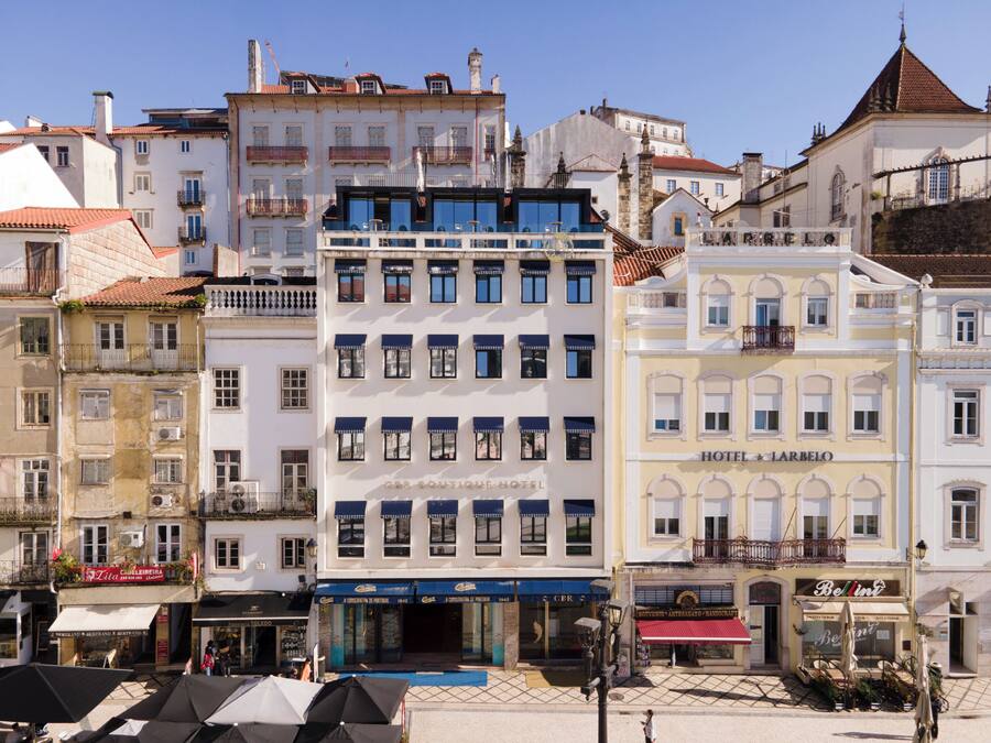 A hotel with multiple floors, large windows, and a prominent sign.