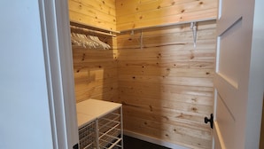 A small, enclosed room with wooden walls and a sloped ceiling.