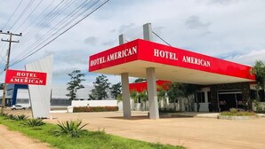 A Hotel American sign with a red canopy and a white base. - Hotel American (Ariquemes)