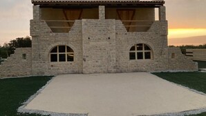 A stone building with two arched windows and a flat roof. - Ximitadi Estate (East Mani)