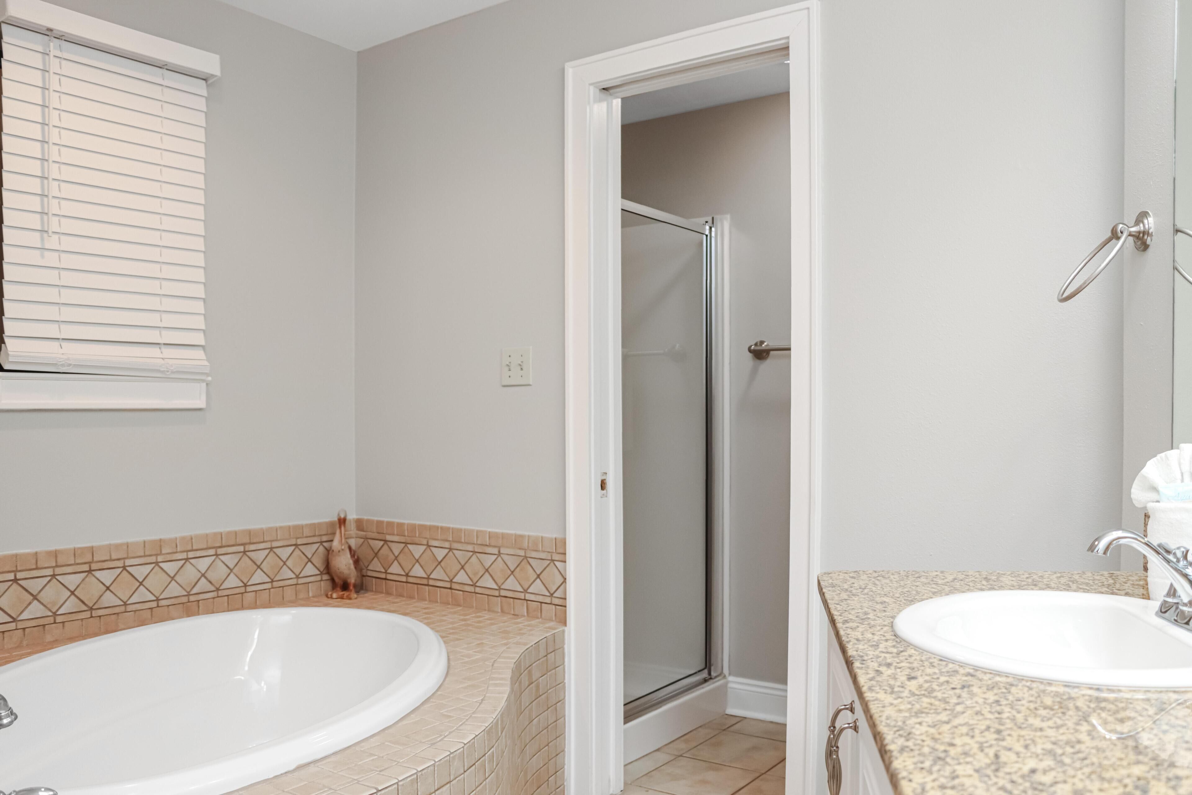 A bathroom with a bathtub, a shower, and a sink.