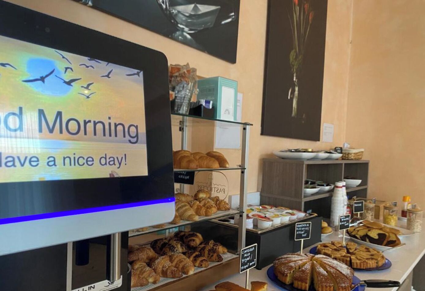 A breakfast buffet with various pastries and a sign that reads "Good Morning Have a nice day!"