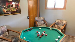 A pool table with balls, surrounded by four armchairs. - Hometown Cozy  ADA friendly, Kids, Pets, King Bed! Quiet, Safe Neighborhood (Medina)