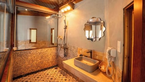 A bathroom with a tiled floor, a sink, a mirror, and a shower. - Sinai Bungalow & Hotel SaPa (Sa Pa)