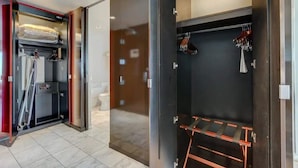 A hotel room with a closet containing hanging clothes and a shoe rack. - Strip View Luxury Studio No Resort Fee Palms Place (Las Vegas)