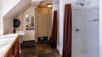 A bathroom with a shower, a sink, and a mirror.