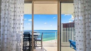 A balcony with a view of the ocean and a building in the background. - Beachfront Master w/balcony access! Shores of Panama (Panama City Beach)