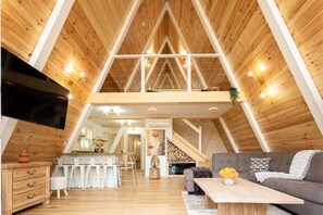 Relax in this stylish loft with a high ceiling, modern kitchen, and comfortable seating area.