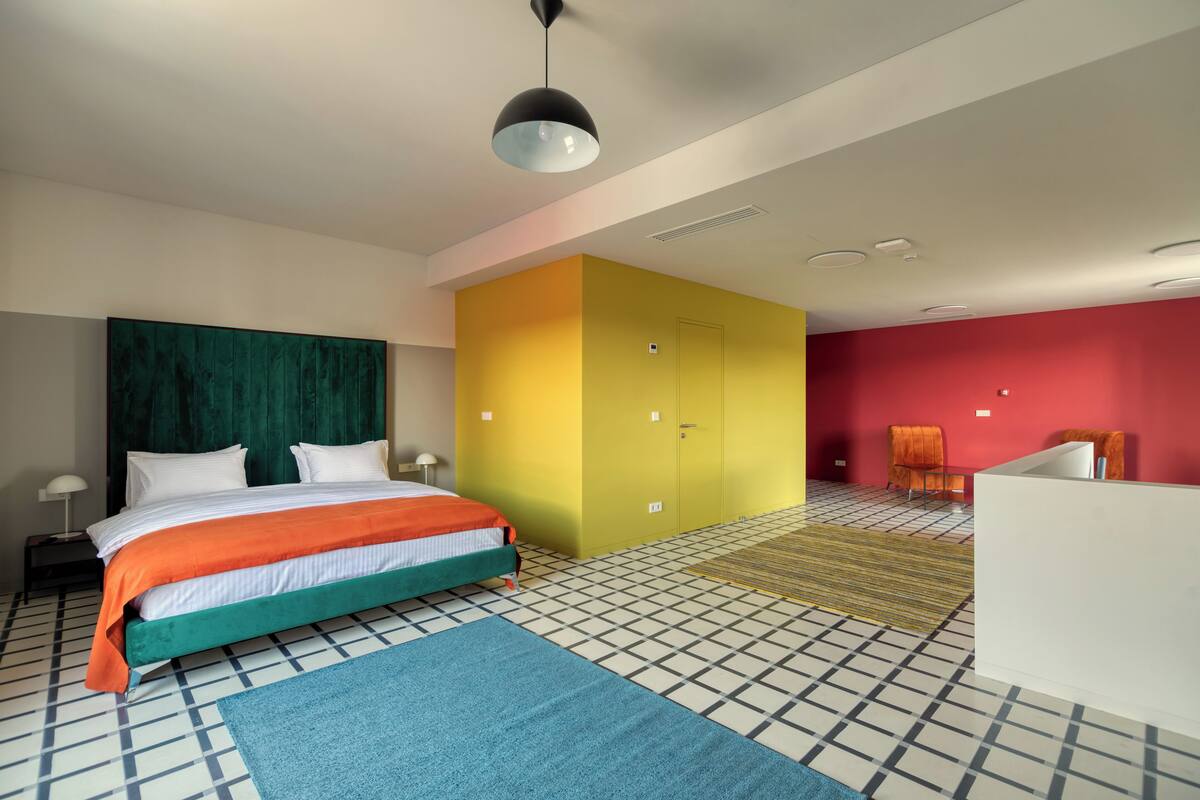 Ein modernes Hotelzimmer mit Bett, Schreibtisch und Stuhl.