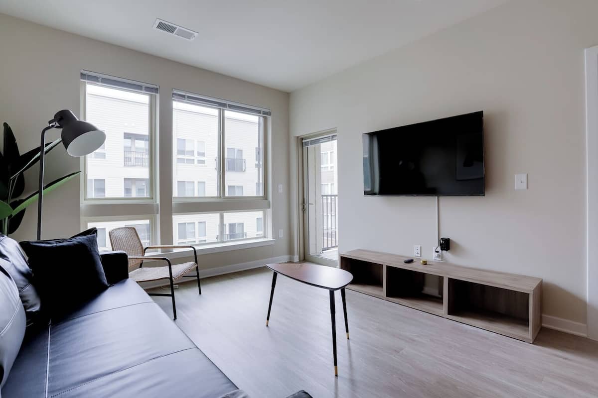 Business Apartment, 1 Bedroom, Balcony | Living area | 50-inch Smart TV with cable channels