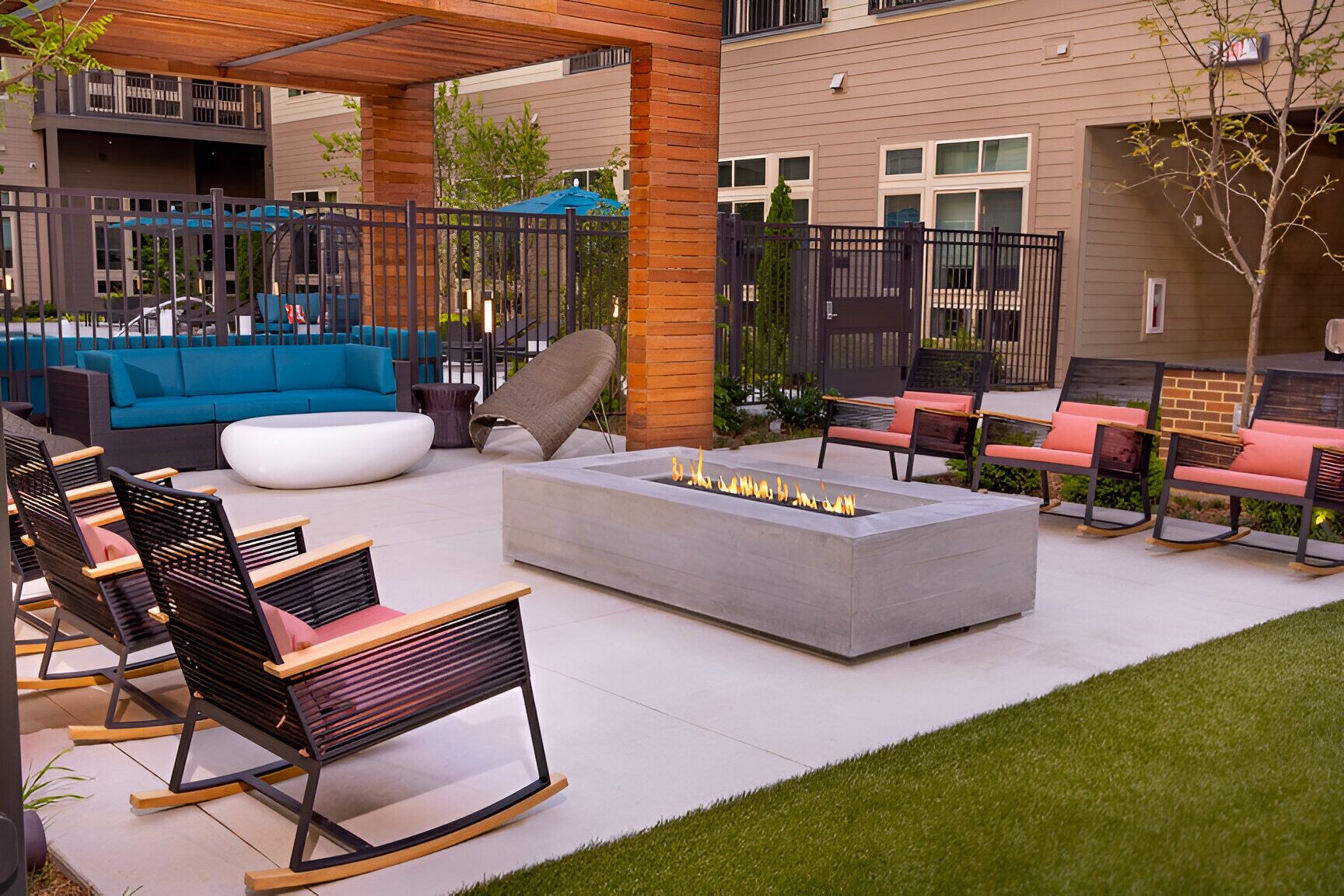 Un patio al aire libre con una chimenea, asientos y una zona cubierta.