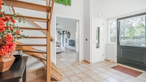 A modern interior with a staircase, a living area with a sofa, and a view through a door. - 4 bedroom lovely home in Havelte (Havelte)