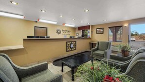 A hotel reception area with a reception desk, seating, and a clock on the wall. - Surestay Plus Hotel by Best Western Silver City (Silver City)