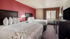 A hotel room with two beds, a desk, a TV, and a window with curtains. - Surestay Plus Hotel by Best Western Silver City (Silver City)