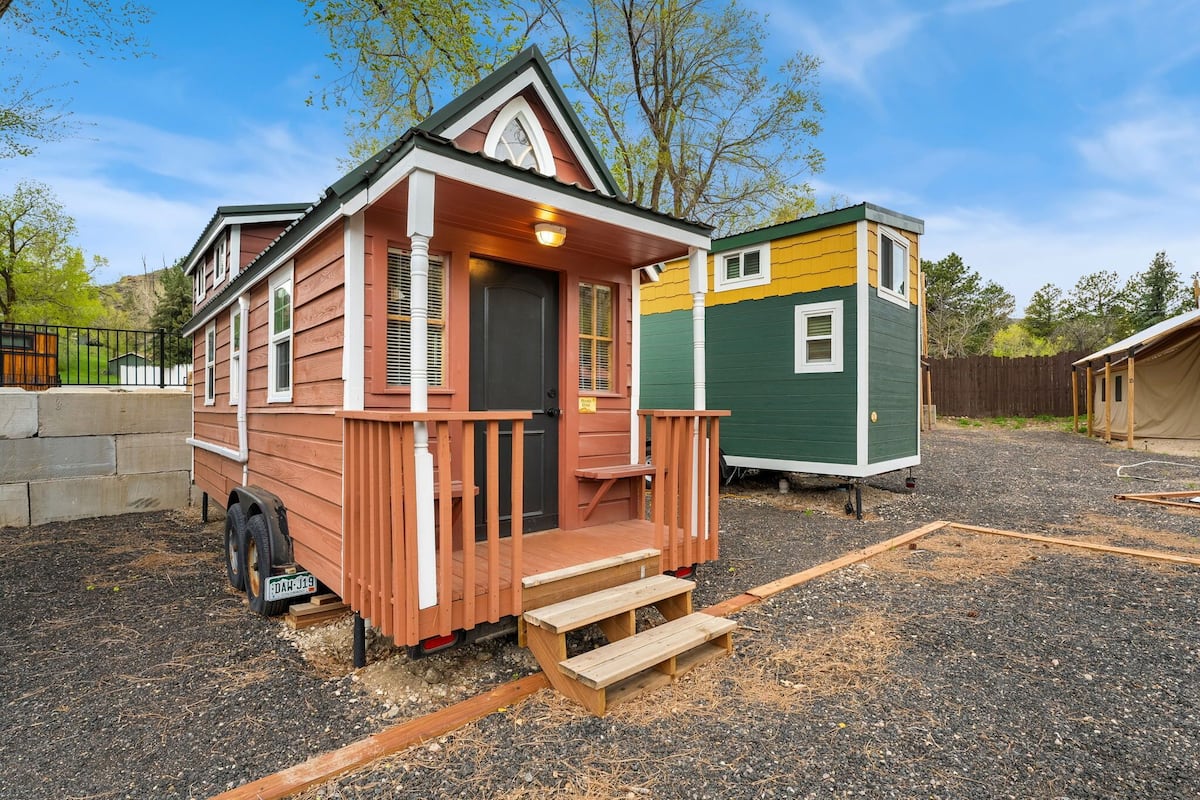 A small, single-story house with a porch and a front door.