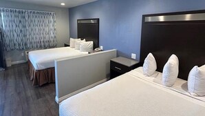 A hotel room with two beds, a nightstand, a dresser, and a window with curtains. - Motel6 Yuba City, CA (Yuba City)