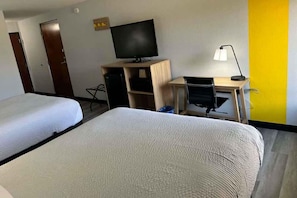 A hotel room with two beds, a desk with a computer, a television, and a lamp. - Super 8 by Wyndham Alexandria LA (Alexandria)