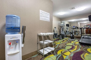 A fitness center with exercise equipment, a water dispenser, and a sign detailing safety rules. - Super 8 by Wyndham Alexandria LA (Alexandria)