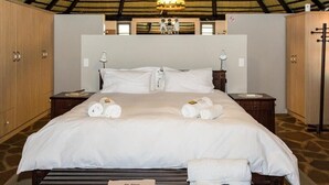 A spacious bedroom with a large bed, wooden wardrobe, and a ceiling fan. - Mountain View Villa (Pacific Harbour)