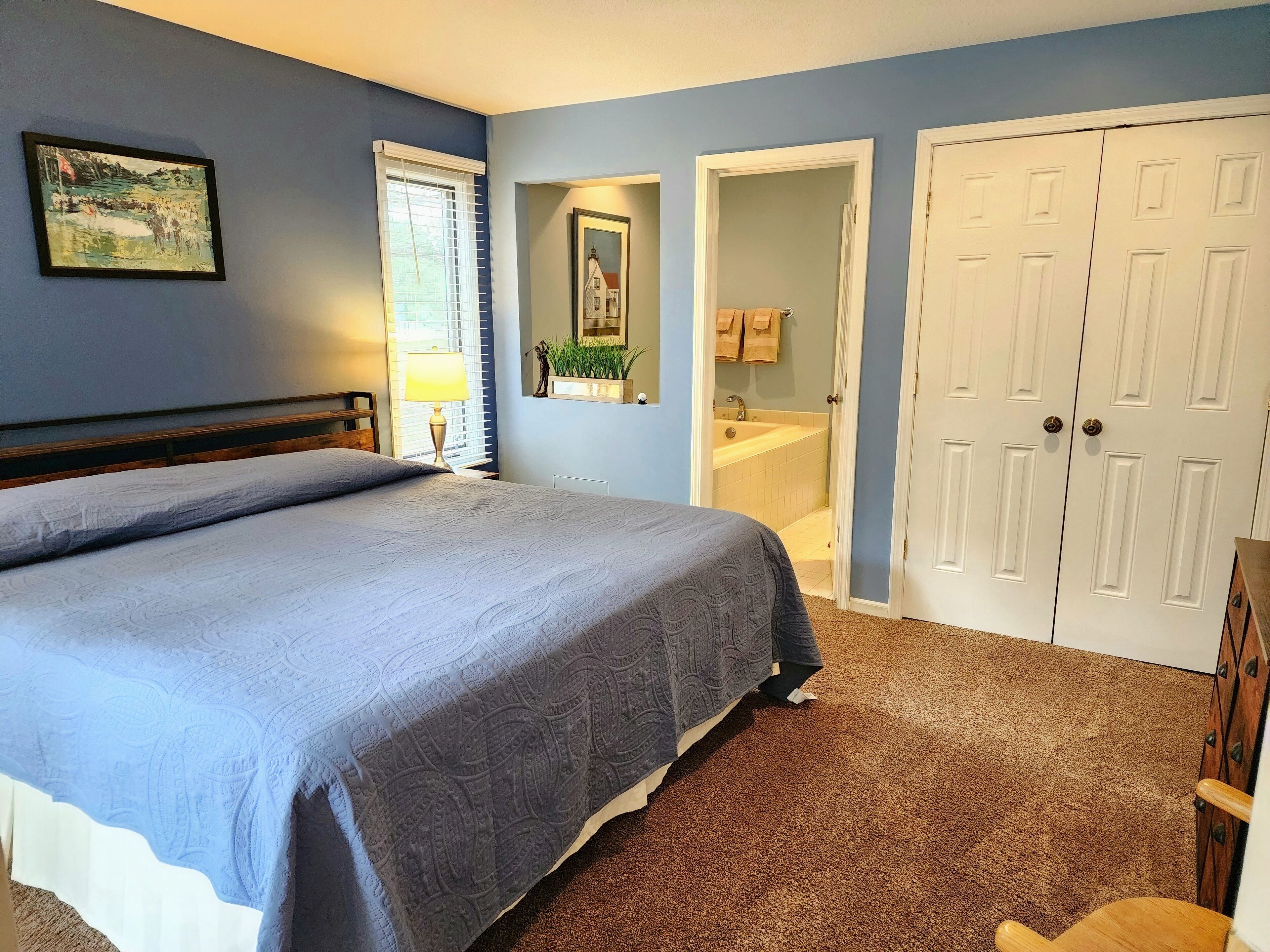 Another view of the primary bedroom with king bed