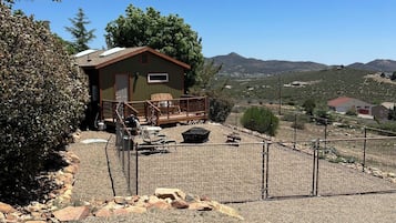 Guest house with a covered porch and scenic views of rolling hills and mountains.