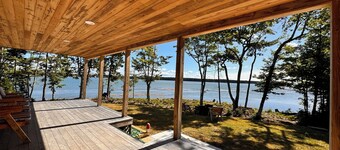 Shoreline solitude, newly built, nestled between evergreens and Pigeon Hill Bay