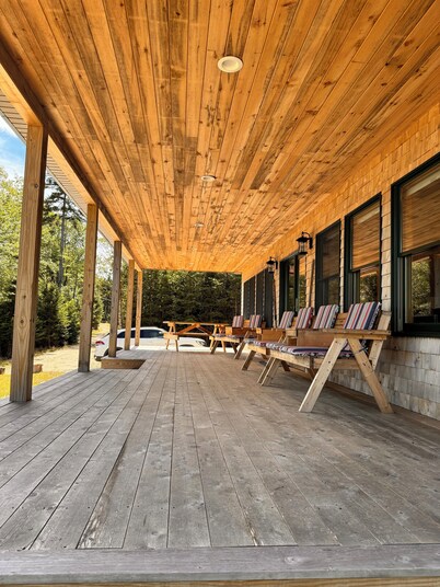 Shoreline solitude, newly built, nestled between evergreens and Pigeon Hill Bay