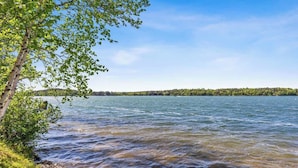 A lake with a tree on the left and a distant shoreline. - Cabin 2 at Timberlane Resort on Long Lake (Park Rapids, MN)