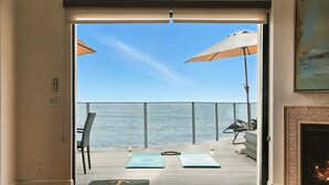 A room with a view of the ocean, a fireplace, and two yoga mats on the floor. - Luxury, renovated, oceanfront home with incredible deck & ocean views - dog friendly! (La Jolla)