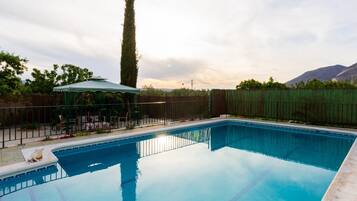 Relax by the pool surrounded by a serene mountain view.