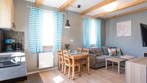 A cozy living space with a dining area, kitchen, and seating area. - Beach front home in Nowecin with sauna (Nowecin)