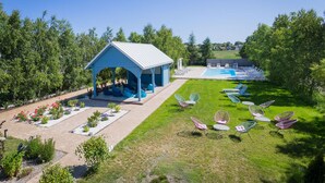 A blue pavilion with seating, a pool, and outdoor chairs. - Beach front home in Nowecin with sauna (Nowecin)
