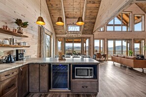 A spacious kitchen with wooden cabinets, a built-in microwave, and a large island.