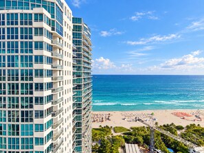 A high-rise hotel with multiple balconies overlooking a beach and the ocean. - 2/2 Direct Ocean at the Setai (Miami Beach)