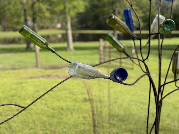 A glassblowing installation with various glass pieces suspended in an outdoor setting.